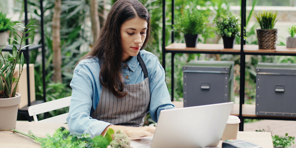 Dig Marketing-Sherwood Park, Alberta-Plant Nursery Advertising-garden center owner at laptop